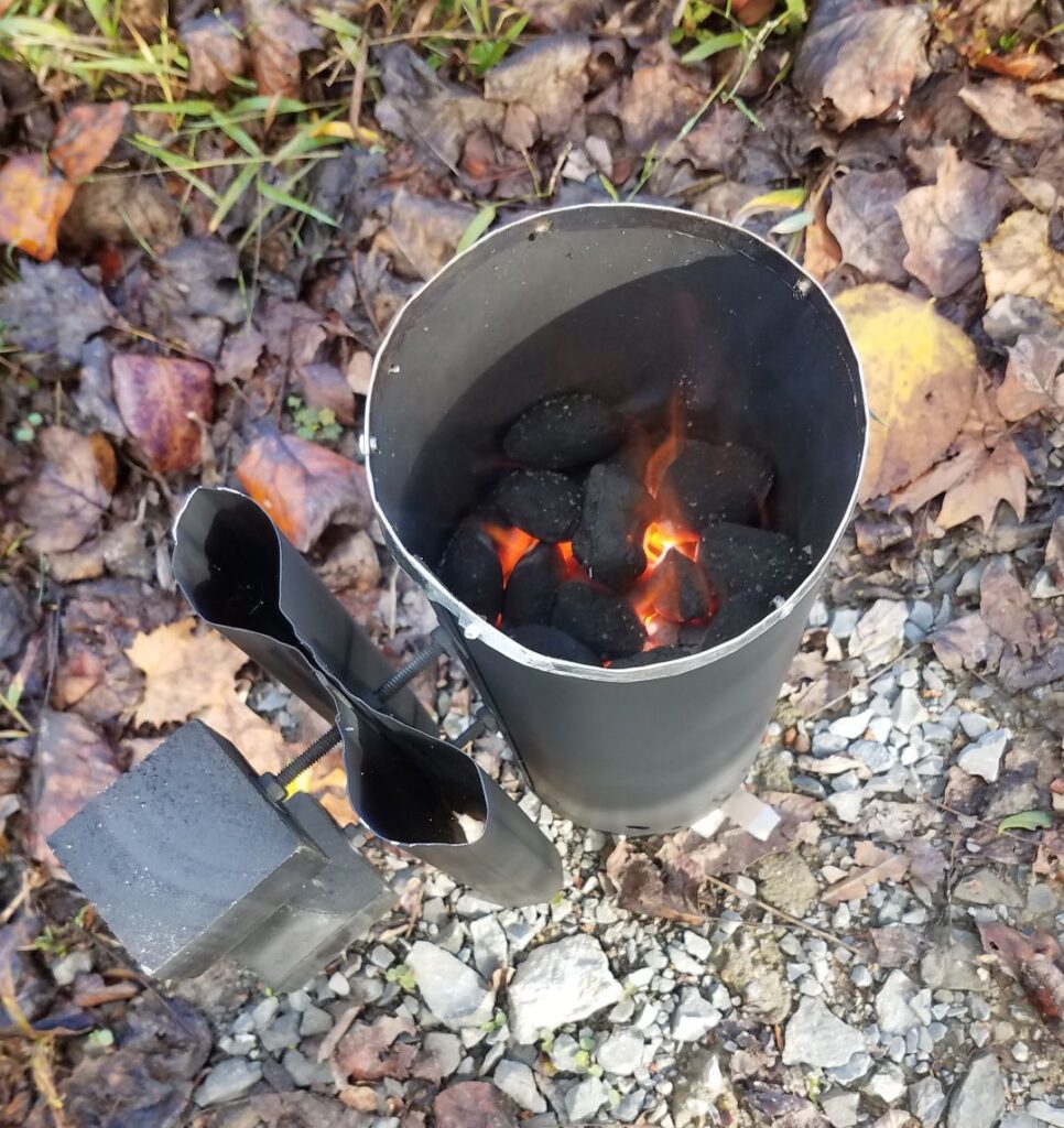 Charcoal briquettes burning inside the homemade chimney starter